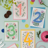 Selection of four Ruby & Bo plantable age cards on a mint green background