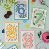 A selection of four Ruby & Bo plantable age cards on a mint green background