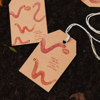 Feed the Worms Kraft Gift Tags on a pile of compost