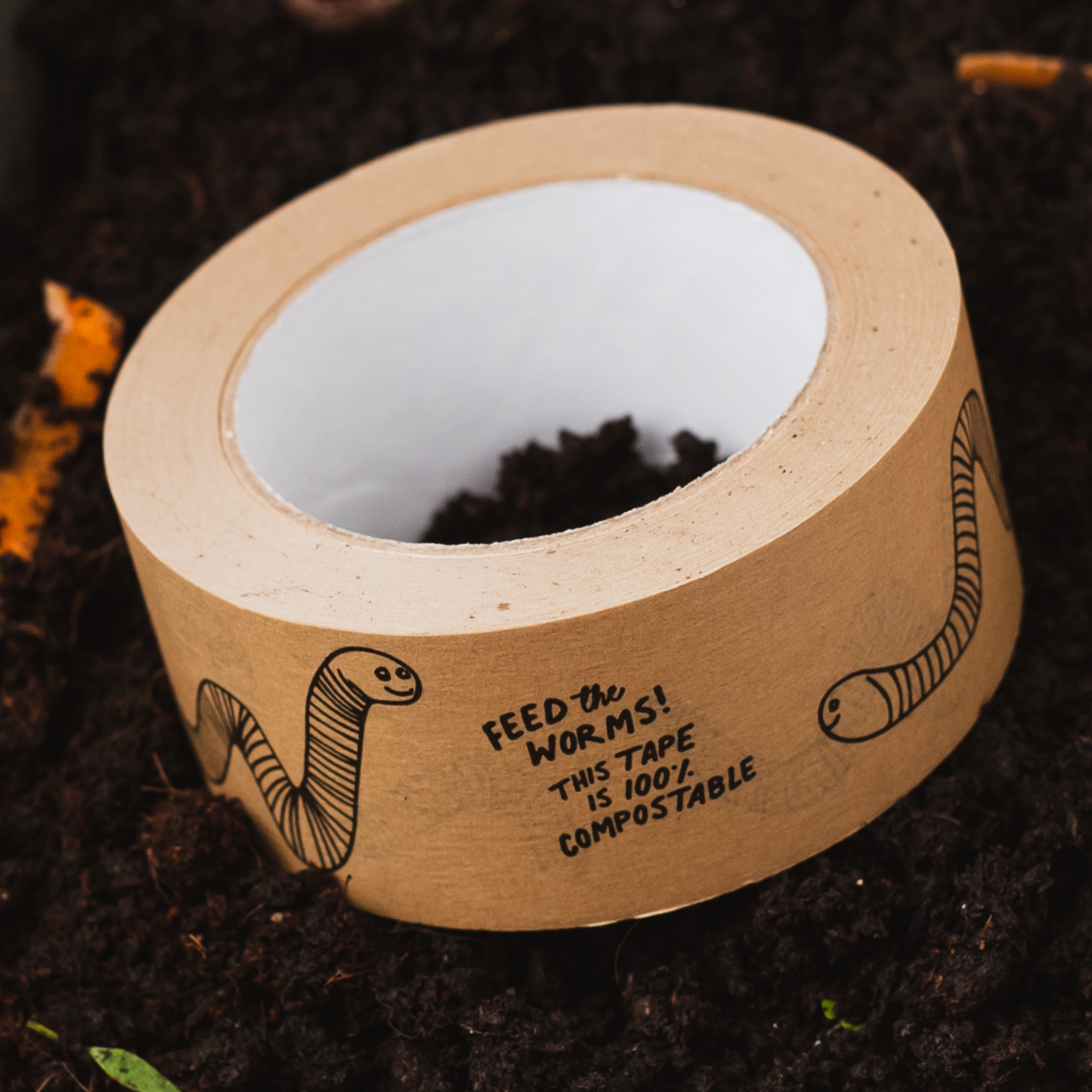 Feed the worms kraft paper tape on a pile of compost