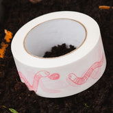 Feed the worms paper tape on compost pile