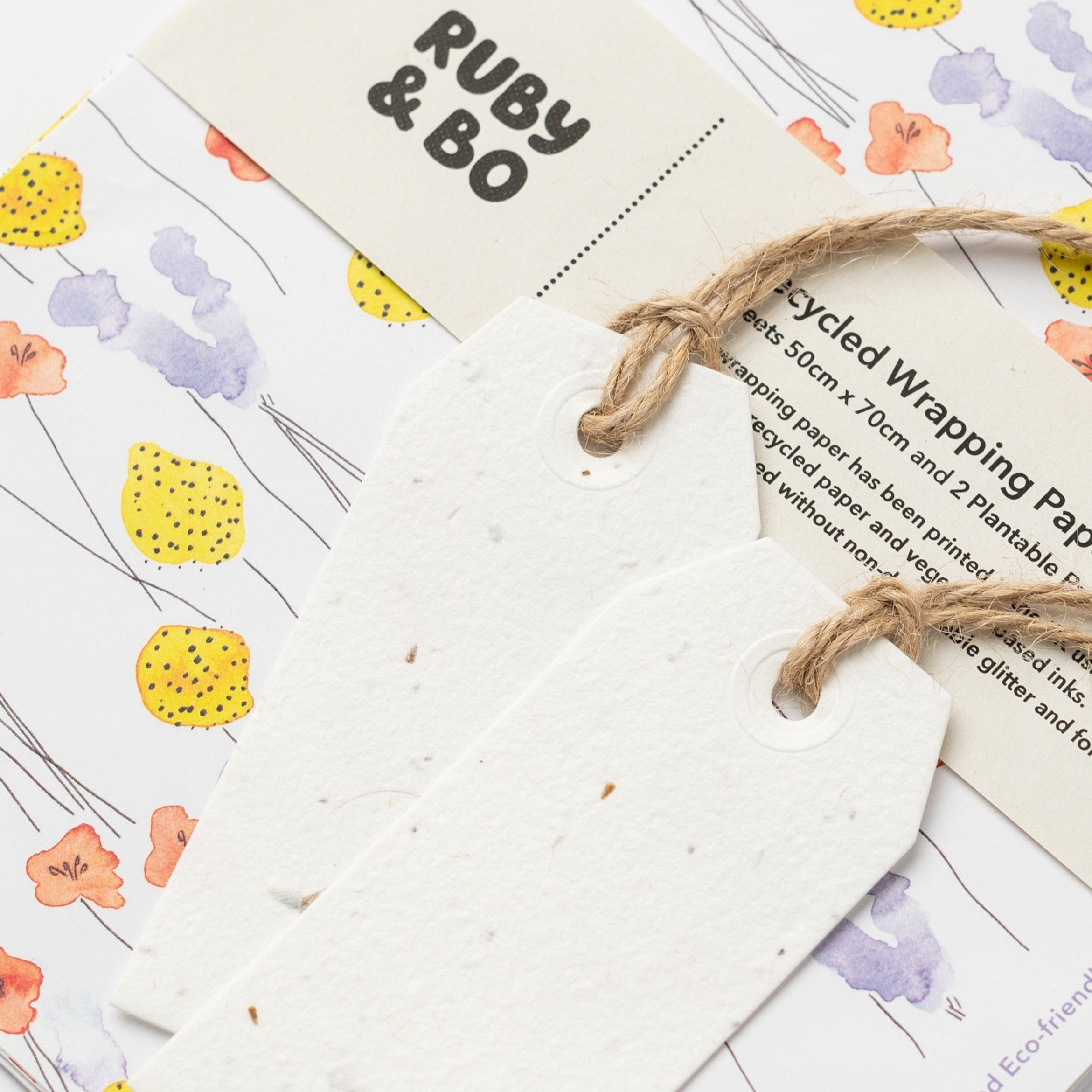 close up of plantable gift tags on billy button wrapping paper