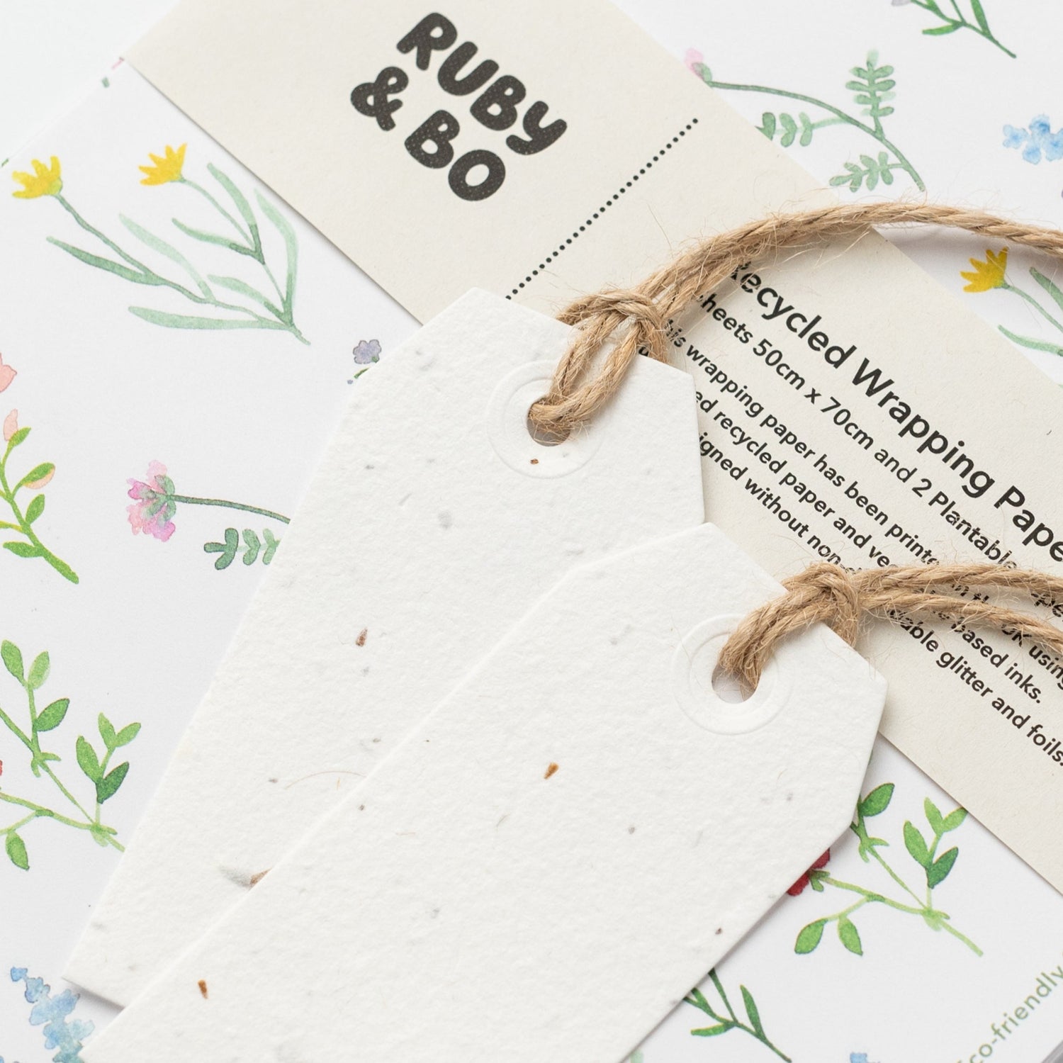 A close up of Ruby &amp; Bo wildflower recycled wrap and plantable tag set